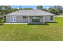 This backyard offers a covered patio, lush lawn and serene views making it an outdoor retreat at 226 Locust Ln, Ocala, FL 34472