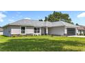 Charming single-story home with a well-manicured lawn and a gray roof at 226 Locust Ln, Ocala, FL 34472