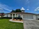 Inviting single-story home with well-kept lawn, tidy flowerbeds, and attached two-car garage, perfect for suburban living at 2515 Nw 53 Ave, Ocala, FL 34482