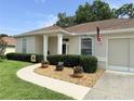 Charming home featuring a well-manicured front yard, inviting pathway and an American flag at 2515 Nw 53 Ave, Ocala, FL 34482