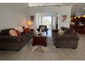 Inviting living room features cozy seating and a decorative rug over tile flooring at 2515 Nw 53 Ave, Ocala, FL 34482