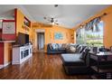 Bright, open living room with hardwood floors, a comfortable sectional, and large windows at 32 Dogwood Drive Loop, Ocala, FL 34472