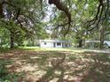 Cozy single-story home nestled among mature trees on a spacious lot, offering a peaceful and private retreat at 3418 Se 94Th St, Ocala, FL 34480