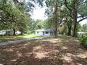 Quaint home with a long driveway, situated on a spacious lot with mature trees and a serene setting at 3418 Se 94Th St, Ocala, FL 34480