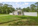Inviting single-story home with a fenced yard and a cozy front porch at 5063 Se 168Th Ter, Ocklawaha, FL 32179