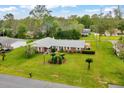 Aerial view of a home with a lush lawn, mature landscaping and a brick exterior at 616 Se 40Th Ave, Ocala, FL 34471