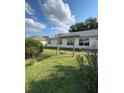 Spacious backyard with lush green grass and partial pergola at 6241 Sw 84Th Pl, Ocala, FL 34476