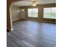 Bright, open living room with newly installed gray vinyl floors and a ceiling fan at 6241 Sw 84Th Pl, Ocala, FL 34476