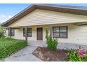 Charming covered front porch with decorative landscaping and a view of the home's exterior at 6320 Se 42Nd Ct, Ocala, FL 34480