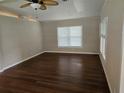 Neutral toned Living room with wood look floors, ceiling fan and lots of light at 741 Truman Ave, Lady Lake, FL 32159
