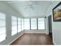 Bright sun room with lots of windows, ceiling fan, and wood-look floors at 741 Truman Ave, Lady Lake, FL 32159