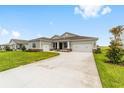 Spacious home featuring a large driveway and attached garages at 7513 Sw 56Th Pl, Ocala, FL 34474