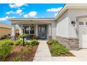 Inviting front porch with stone accents, offering a cozy spot for relaxation at 7891 Sw 89Th Cir, Ocala, FL 34481