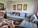 Comfortable living room featuring a large sectional sofa and decorative art pieces at 8368 Sw 105Th Pl, Ocala, FL 34481