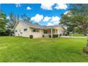 Well-maintained home showcasing lush green lawn and inviting covered porch at 8625 Sw 94Th Ln # A, Ocala, FL 34481