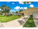 Inviting home featuring a well-kept lawn, a front yard light post, and an attached garage at 8625 Sw 94Th Ln # A, Ocala, FL 34481