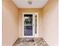 Inviting entrance featuring a decorative storm door and tile flooring with a 'Welcome' mat at 8670 Se 141St Pl, Summerfield, FL 34491