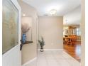 Bright foyer with tile flooring, decorative niche, and views of the dining area at 8670 Se 141St Pl, Summerfield, FL 34491