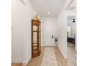 Inviting entryway with tiled floors, a vintage curio cabinet and a clear view of the bedroom at 8989 Sw 57Th Place Rd, Ocala, FL 34481