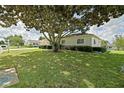 Charming single-story home with well-maintained lawn, mature tree offering ample shade at 9486 Se 173Rd Pl, Summerfield, FL 34491