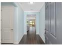 Inviting foyer featuring dark wood floors and calming light blue wall paint at 9805 Sw 95Th Loop, Ocala, FL 34481