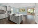 Bright kitchen features stainless appliances, a center island, and elegant light-gray cabinetry at 9805 Sw 95Th Loop, Ocala, FL 34481
