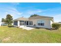 Spacious backyard with screened porch and a concrete patio area at 9952 Sw 58Th Ave, Ocala, FL 34476