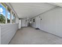 Spacious carport featuring durable flooring and ample room for parking and storage at 10210 Sw 93Rd Ave, Ocala, FL 34481