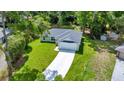 Charming single-story home featuring a well-manicured lawn, long driveway, and a two car garage at 10675 Sw 69Th Ter, Ocala, FL 34476