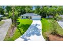 Charming single-story home featuring a well-manicured lawn, long driveway, and a two car garage at 10675 Sw 69Th Ter, Ocala, FL 34476