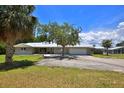 Charming single-story home with mature landscaping, attached garage, and screened-in pool area at 10893 Se 141 Avenue Rd, Ocklawaha, FL 32179