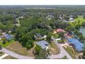 A picturesque aerial view showcasing a well-maintained property nestled within a vibrant, green community at 11645 Mallard Ct, Dunnellon, FL 34432