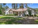 Charming single-story home with stone accents, arched entry, and lush front yard landscaping at 15620 Nw 112Th Ave, Reddick, FL 32686
