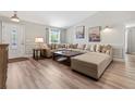 Spacious living room featuring a large sectional sofa, wood floors, and modern decor at 15994 Sw 55Th Avenue Rd, Ocala, FL 34473
