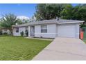 Well-kept single-story home featuring a lush green lawn and a convenient driveway at 18 Banyan Pass, Ocala, FL 34472