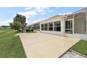 Concrete patio and screened-in enclosure attached to the back of the house at 2002 Enrique Dr, Lady Lake, FL 32159