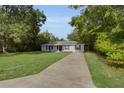 Attractive home with a long driveway and a well-kept lawn at 2263 Moines Ct, Dunnellon, FL 34431