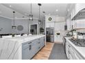 Bright kitchen with white cabinets, marble countertops, stainless steel appliances, and a spacious island at 300 Se Highway 42, Summerfield, FL 34491