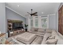 Comfortable living room with a large sectional sofa, neutral color palette, and entertainment center at 300 Se Highway 42, Summerfield, FL 34491