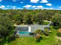 Gorgeous aerial view of a home with pool and lots of trees at 3000 Pine Grove Ln, Lady Lake, FL 32159