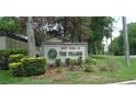 Entrance sign for Patio Homes of the Village is surrounded by manicured landscaping at 3856 Ne 17Th Street Cir, Ocala, FL 34470