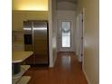 Hallway with wood flooring leading to kitchen and other rooms at 3904 Ne 22Nd St, Ocala, FL 34470