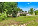 Well-maintained home exterior with a two-car garage and manicured landscaping at 4025 Ne 18Th St, Ocala, FL 34470