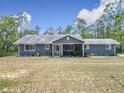 Inviting single-story home with a screened porch and manicured lawn in a serene setting at 4258 Sw Zinnia Ct, Dunnellon, FL 34431