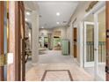 View of the tiled foyer leading to the living room and kitchen, showcasing an open layout at 4465 Se 48Th Place Rd, Ocala, FL 34480