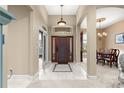 Foyer showcasing tile flooring and an elegant entryway to the dining and living areas at 4465 Se 48Th Place Rd, Ocala, FL 34480