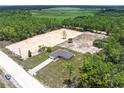 Aerial view of the home and lot with partial clearing surrounded by woods and green space at 5331 Sw 121St Ter, Ocala, FL 34481