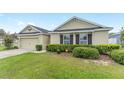 Attractive single-story home with a manicured lawn, two-car garage, and neatly trimmed shrubs adding to its appeal at 6646 Sw 64Th Ave, Ocala, FL 34476