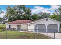 Well-maintained single-level home featuring a two-car garage and a secure chain-link fence at 70 Sapphire Rd, Ocala, FL 34472
