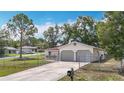 Charming single-Gathering home featuring an attached two-car garage and a chain-link fence surrounding the property at 70 Sapphire Rd, Ocala, FL 34472